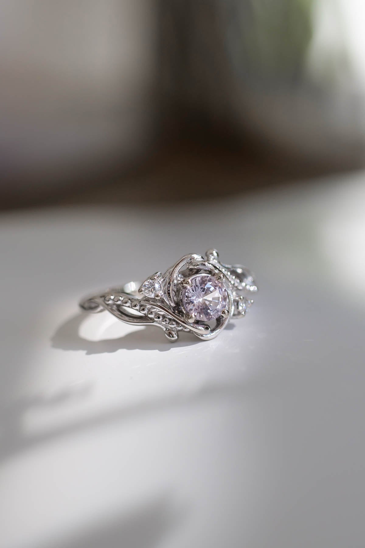 Pink sapphire engagement ring with diamonds  white gold, with small accent diamonds arround the center gemstone